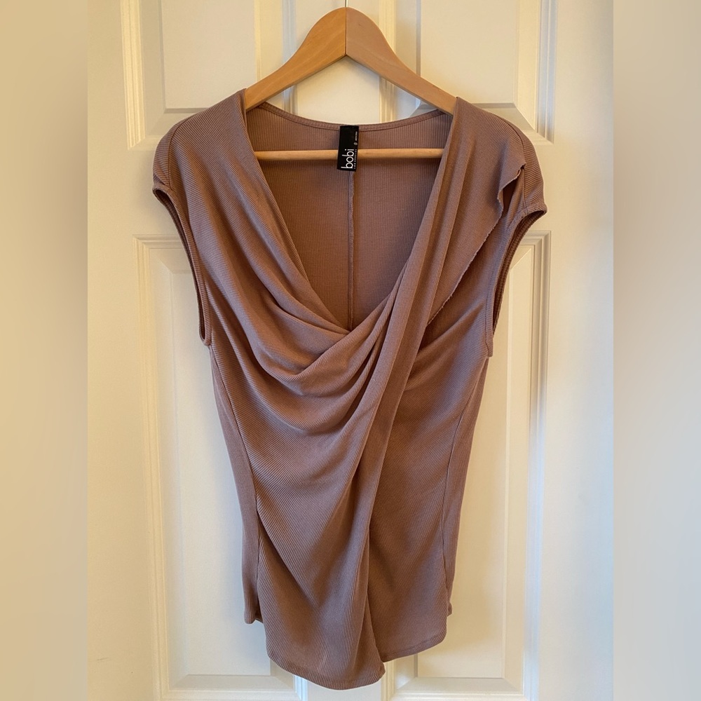 Casual sleeveless rose colored blouse with draped neckline.